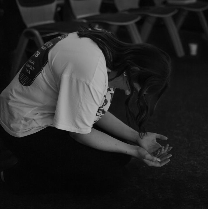 young woman kneeling and praying